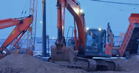 Excavation work at a construction site, excavators and trucks take their places  Stock Footage 147625413