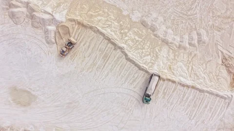 Excavation work happens at a salt mine site where large trucks move and Stock Footage 345455854