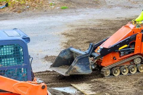 Excavation work in progress at construction site during overcast weather Stock Photos