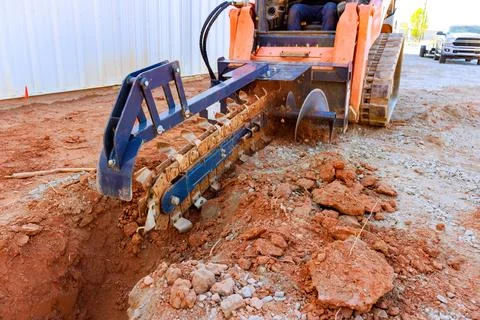 Excavation work underway at a construction site using a track loader with a Stock Photos
