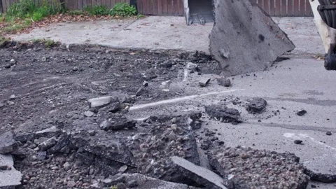 Excavation Work Utilizing Heavy Machinery to Effectively Break Up Concrete Stock-Footage 308333442
