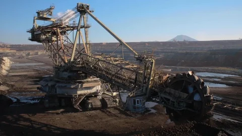 An excavator from above operating in a coal mine in Greece and pan to energy  Video stock 120929115