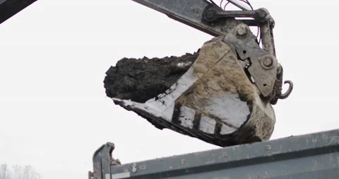 Excavator in action at the construction site. shot: tractor bucket is filling a Stock Footage 145350656