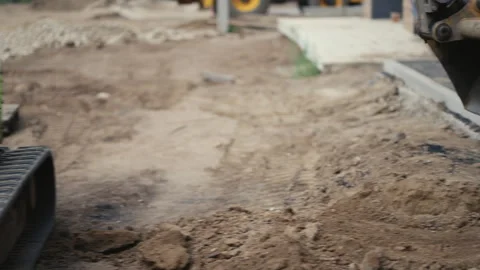 Excavator Actively Digging at a Busy Construction Site for Various Building Stock Footage 312459336