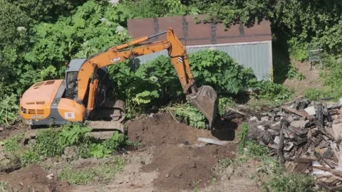 Excavator and builders destroy illegal buildings Stock Footage 148077033