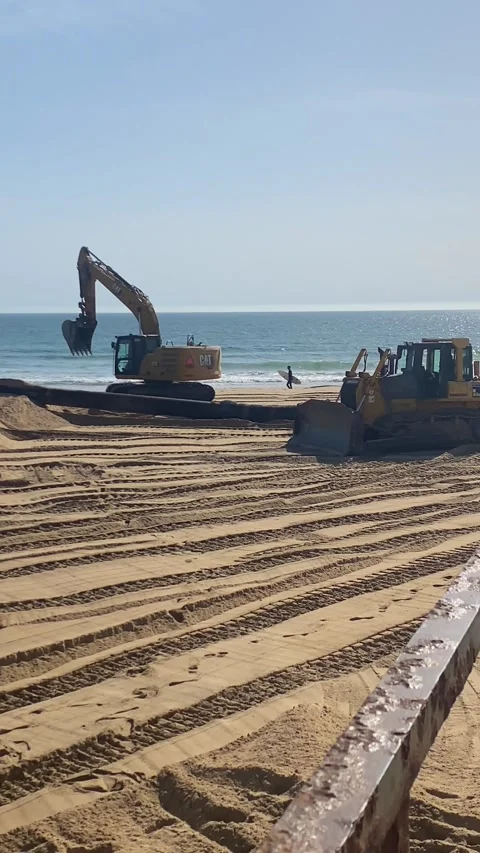 Excavator and Construction Equipment on Beach with Polluted Water Flowing into O 動画素材 343874625