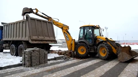An Excavator And Truck Are Loading Soil Stock Footage 65053285