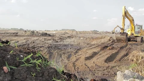 Excavator and trucks driving, digging and loading dirt on a construction yard Stock Footage 136567446
