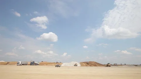 Excavator and trucks driving, digging and loading dirt on a construction yard Stock Footage 136569461