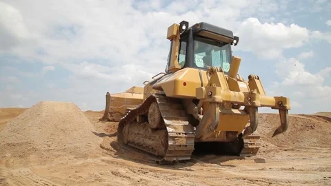 Excavator and trucks driving, digging and loading dirt on a construction yard Stock Footage 136578377