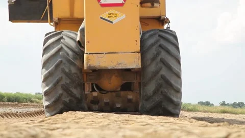 Excavator and trucks driving, digging and loading dirt on a construction yard Stock Footage