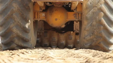 Excavator and trucks driving, digging and loading dirt on a construction yard Stock Footage 136726997