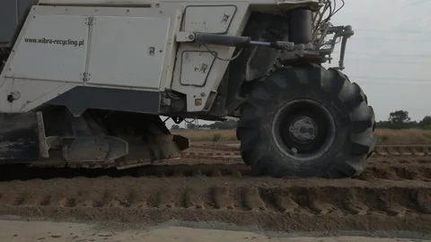 Excavator and trucks driving, digging and loading dirt on a construction yard Stock Footage 136728752
