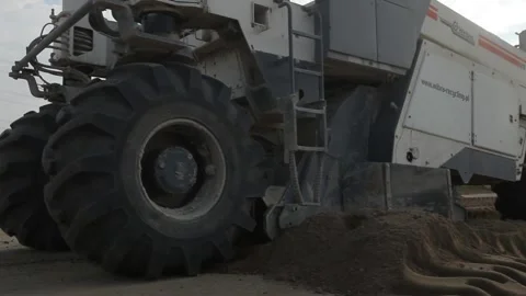 Excavator and trucks driving, digging and loading dirt on a construction yard Stock Footage 136728802