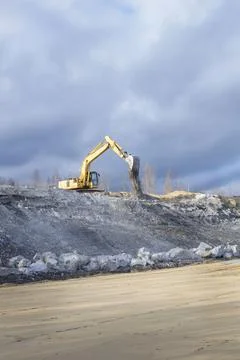 Excavator on the background of the sky. Stock Photos