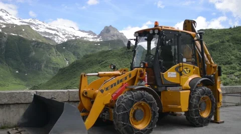 Excavator on the background of snow-capped Alps Stock Footage 51916655