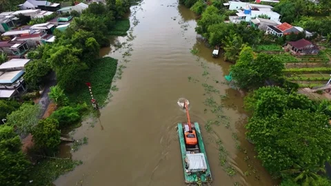 Excavator on a barge moving along an endless rural canal Stock Footage 341229662