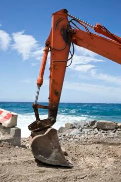 Excavator on the beach Stock Photos