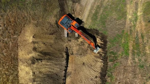 Excavator with big shovel Excavator digging soil pits on construction site. Stock Footage 304580018