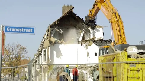 Excavator breaking down a house - 4K Stock Footage 69181592