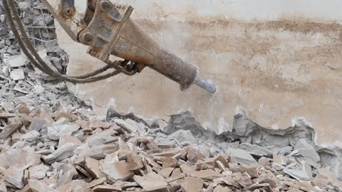 Excavator breaking the side of an old swimming pool, slow motion. Stock-Footage 170659982
