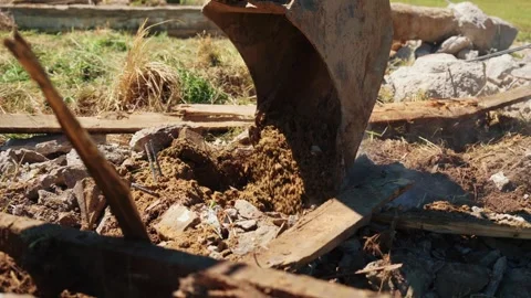Excavator bucket digging dirt and debris Stock Footage 337830642