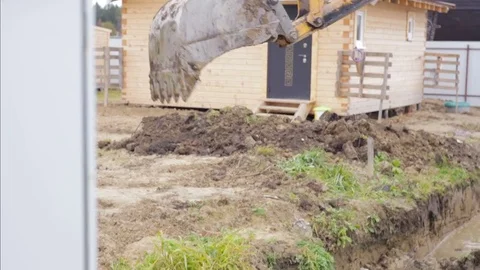 Excavator bucket digging a drainage ditch on a construction site. Building. Stock Footage 73042586