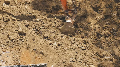 Excavator Bucket Digging into Soil at Construction Site Stock Footage 314522279