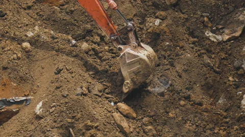 Excavator Bucket Digging into Soil at Construction Site Stock Footage 314522905