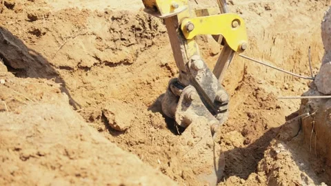 Excavator bucket digging trench at construction site 動画素材 341294432