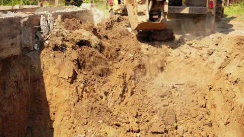 Excavator bucket digging trench on construction site 動画素材 341294504