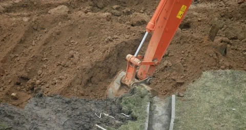 The excavator bucket digs the ground. Construction. Stock Footage 166902159