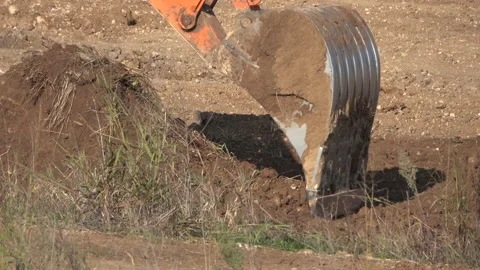 Excavator bucket digs the ground Stock Footage 163159962
