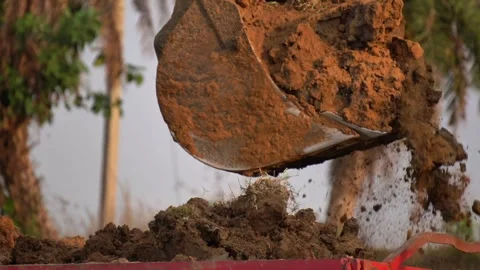 Excavator Bucket Loading Soil into Tractor at Indian Construction Site. Stock Footage 331958403