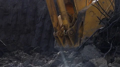 Excavator bucket is picking up the ground in the open pit Stock Footage 83389064