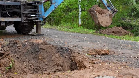 Excavator bucket with soil during digging process Stock Footage 316592813
