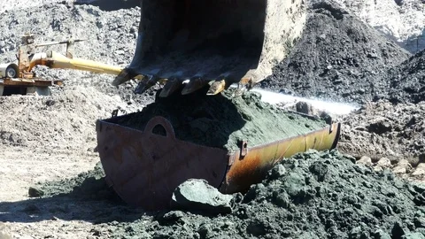 The excavator bucket spreads the bulk of the soil in an iron container Stock Footage 80285686