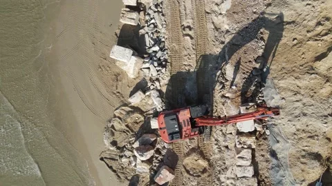 Excavator build a wall  from boulder on the beach Video stock 144555272