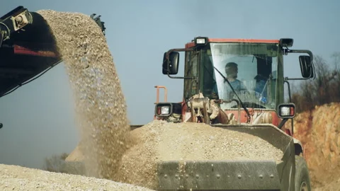 Excavator bulldozer operator loading gravel,stone crushing machine in quarry Video stock 294097122