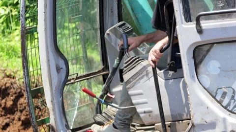 Excavator Cab with Worker Managing Controls Stock Footage 277875808