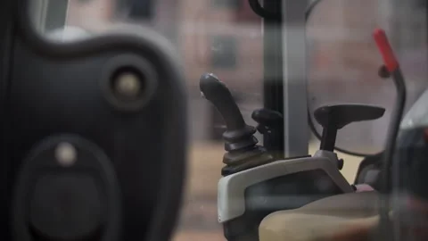 Excavator cabin controls with joysticks inside operator cab Stock Footage 323871027