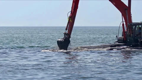 Excavator Cleaning Garbage and Sewage Pits in the Sea Stock Footage 272277672