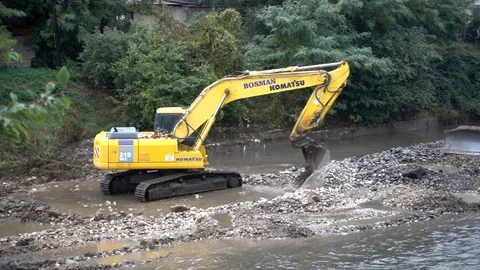 The excavator cleans the river - 3 Stock Footage 81373523