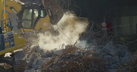 Excavator clearing up a construction site. Removing the metal debris Stock Footage 250540590