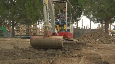 Excavator clearing road Stock Footage 168246369
