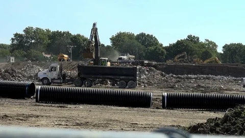 An Excavator Clears Rubble from a Demolished Shopping Center Stock Footage