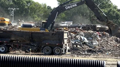 An Excavator Clears Rubble from a Demolished Shopping Center Stock Footage