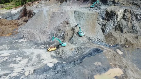 Excavator climbing a rocky mountain in a mining area Stock Footage 312274336
