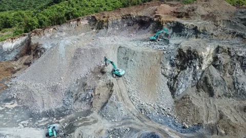 Excavator climbing a rocky mountain in a mining area Stock Footage 312274341