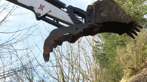 Excavator closeup working and digging holes Stock Footage 75249549